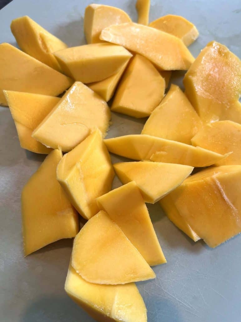 Close-up of evenly chopped Philippine Carabao (Manila) mango pieces on a cutting board, ready for snacking or adding to recipes.