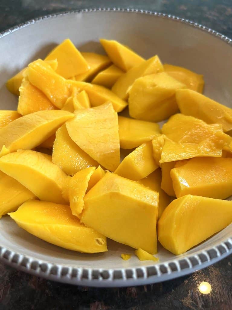 Bowl filled with freshly cut Philippine Carabao (Manila) mango slices, ready to serve or use in mango-based recipes.
