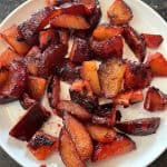 Plate of caramelized sauteed plums cooked on the stovetop, showcasing their rich color and tender texture from the Sauteed Plums Recipe.