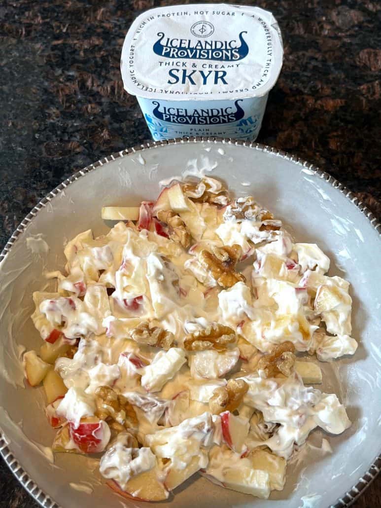 Skyr bowl with apples and walnuts served in a white dish, topped with creamy Icelandic yogurt—an easy, high-protein breakfast.
