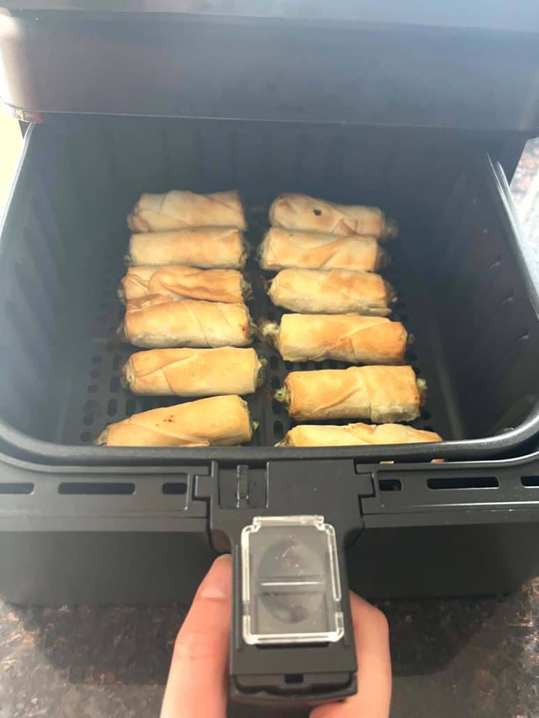 Air fryer basket filled with golden, crispy borek bites just after cooking—showcasing the perfect result.