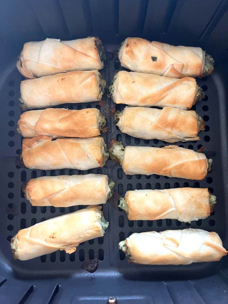 Golden, air-fried borek bites inside the air fryer basket—freshly cooked and ready to serve.