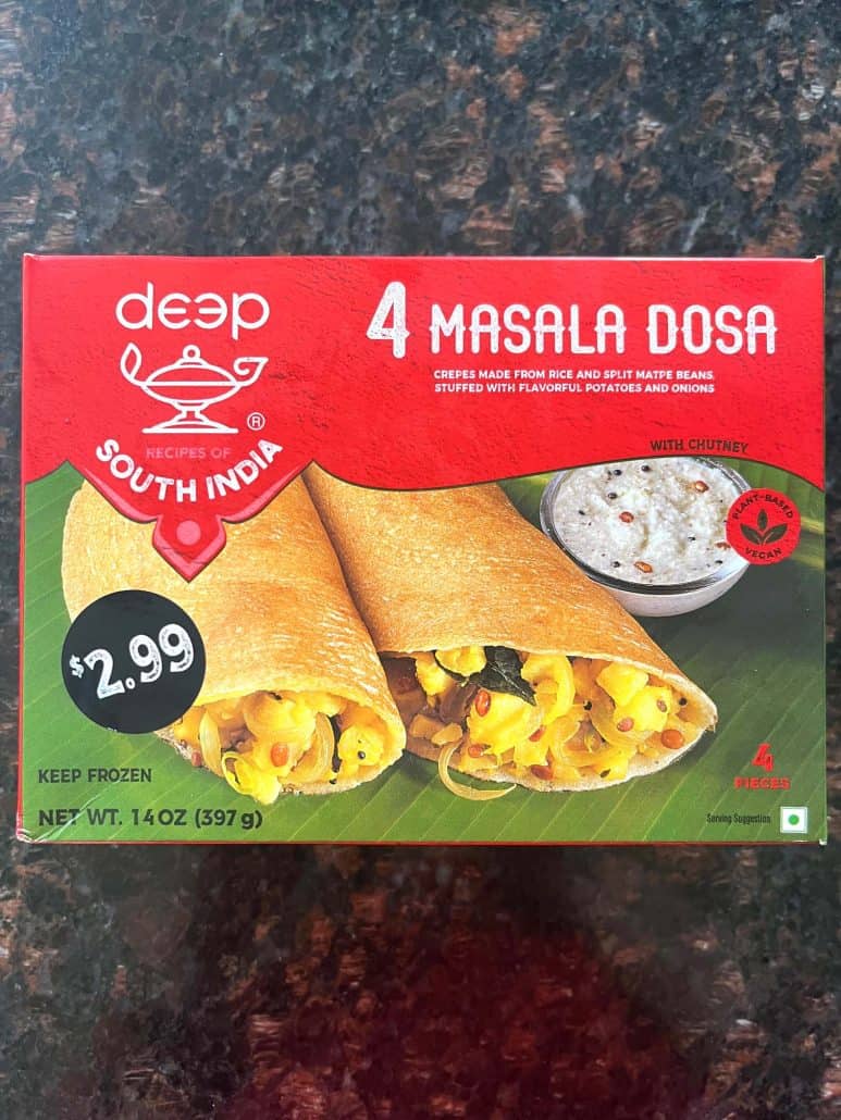 Box of frozen masala dosa shown on a kitchen counter—used in the air fryer recipe to make crispy Indian crepes with spicy potato filling.