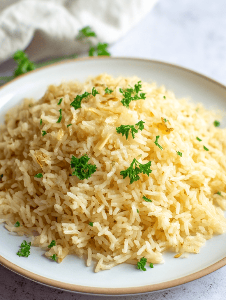 Fluffy and golden garlic butter rice garnished with fresh parsley, perfect as a flavorful side dish.