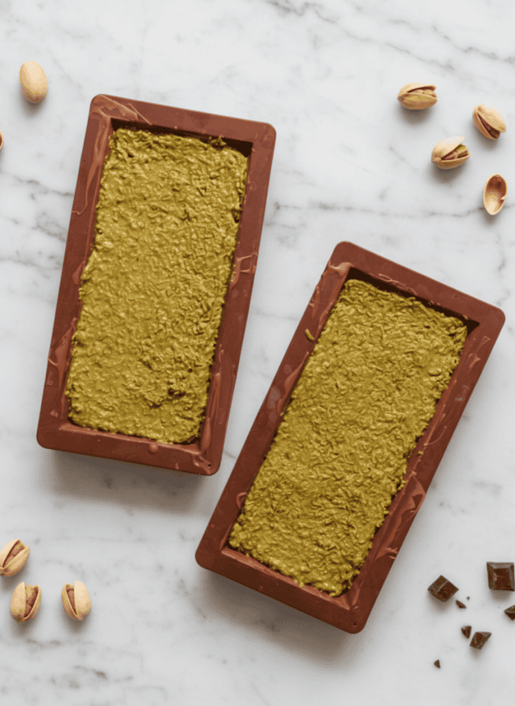 Chocolate bar molds filled with the crunchy pistachio and kataifi mixture.