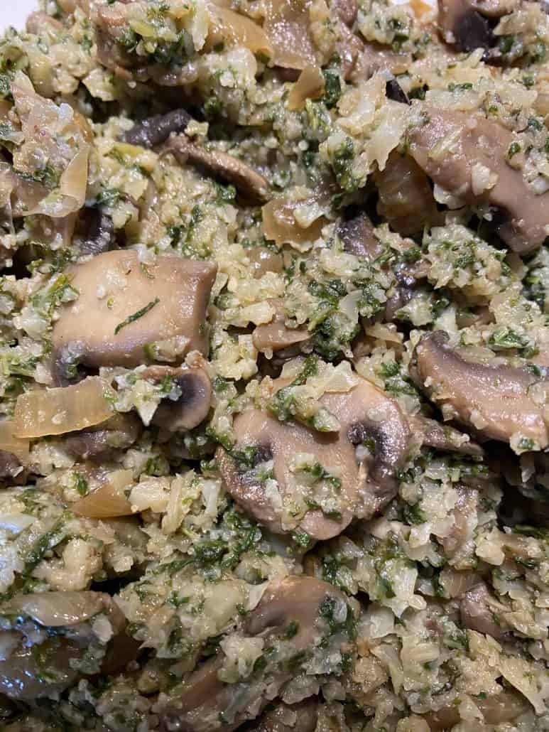 Detailed close-up of sautéed mushrooms, cauliflower rice, and mustard greens – highlighting the texture and savory blend in this healthy vegetable stir-fry.