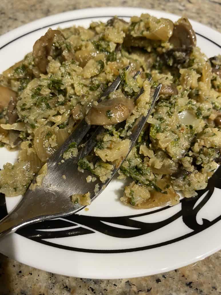 Extreme close-up of a forkful of Mustard Greens with Mushrooms and Cauliflower Rice – showing the tender texture and veggie-packed goodness of this healthy low-carb dish.