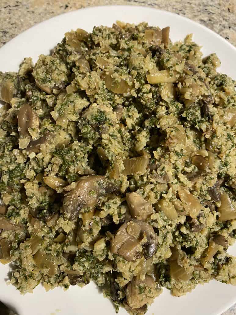 Overhead view of freshly cooked Mustard Greens with Mushrooms and Cauliflower Rice on a plate.