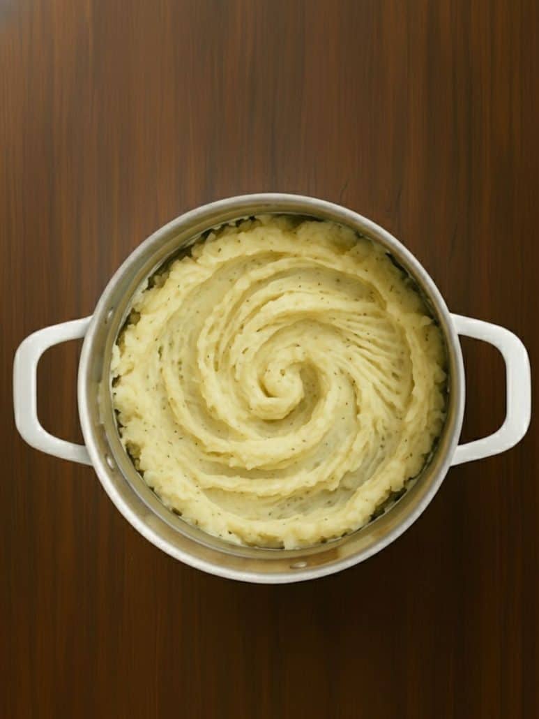 Pot of freshly whipped roasted garlic mashed potatoes with a smooth, swirled topโready to serve as a comforting side dish.Select 72 more words to run Humanizer.