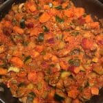 Sweet Potato Mushroom and Zucchini Skillet cooking in a large pan.