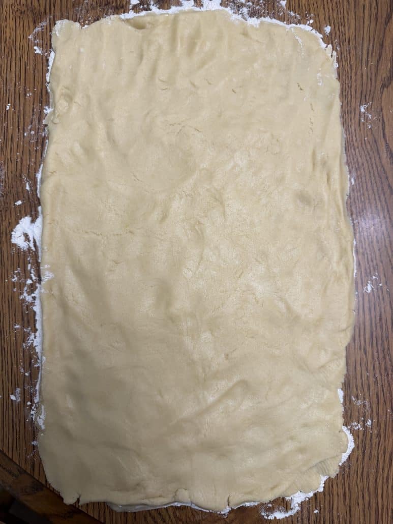 Rolled out sugar cookie dough for No Chill Cinnamon Roll Cookies, ready for cinnamon filling.