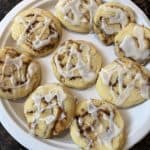 Plate of No Chill Cinnamon Roll Cookies drizzled with glaze, freshly baked and ready to serve.