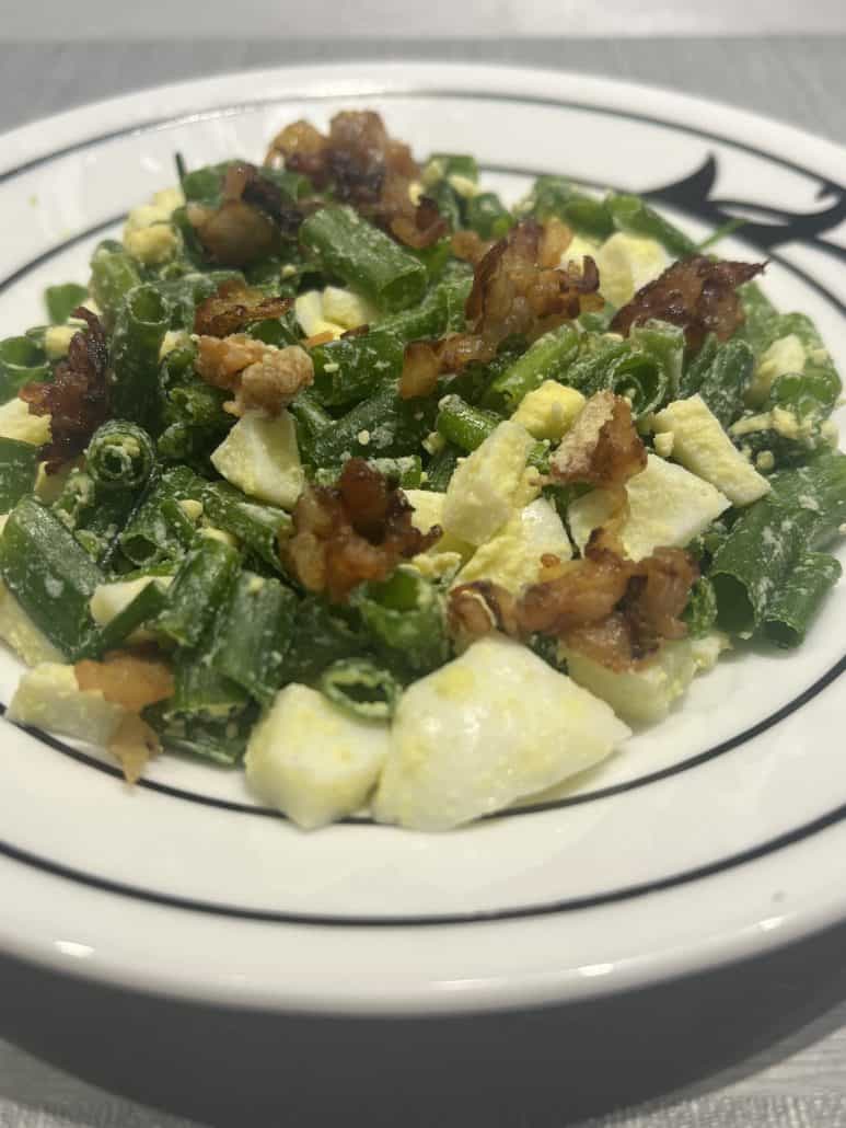 Close-up of Green Onion, Egg, and Bacon Salad highlighting crispy bacon, chopped eggs, and fresh green onions.