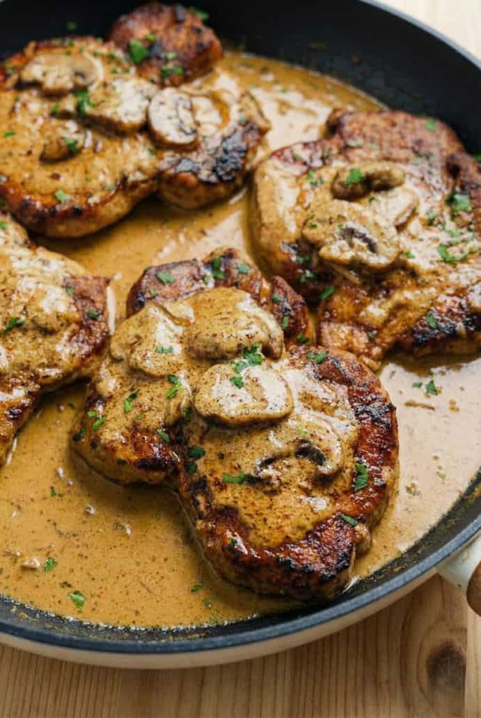 Pork chops smothered in creamy mushroom sauce, shown in the Mushroom Pork Chops recipe for a stovetop dinner.