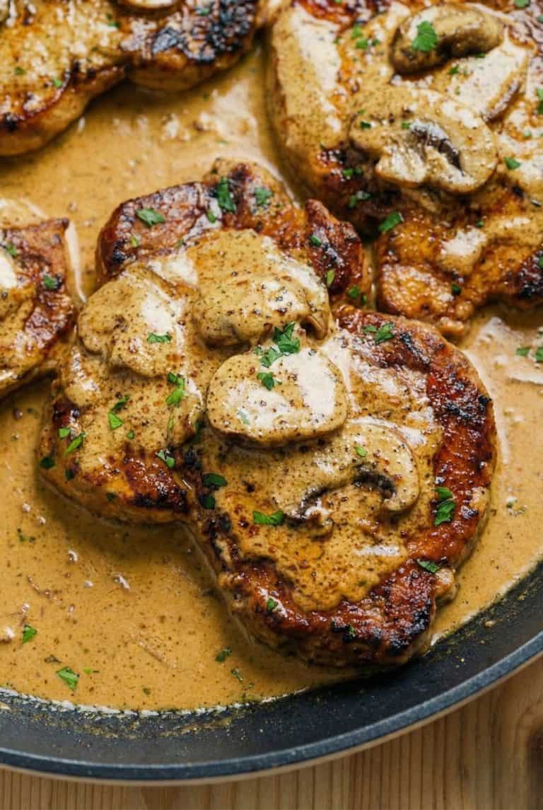 Close-up of tender pork chops in creamy mushroom sauce, as featured in the Mushroom Pork Chops stovetop recipe.