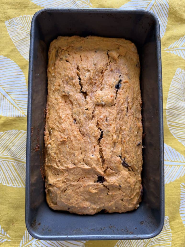 Golden-brown sweet potato bread cooling in a loaf pan, as featured in the step-by-step recipe tutorial.