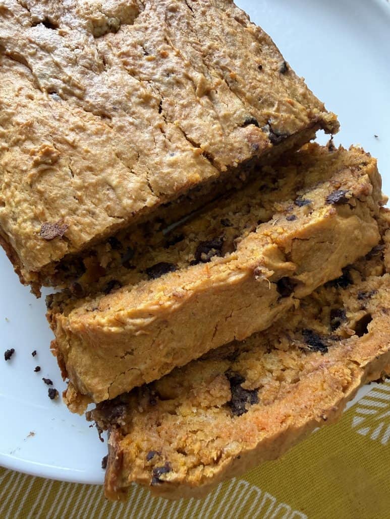 Sliced sweet potato bread with chocolate chips on a plate, showing its moist texture and rich flavor from the recipe.