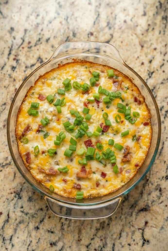 Cheesy Baked Buffalo Chicken Dip in a glass baking dish, fresh from the oven and topped with melted cheese and green onions. A hot and easy appetizer for parties or game day.