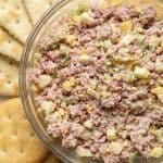 Bowl of creamy ham salad served with round and square crackers. Perfect for snacking, sandwiches, or a quick appetizer.