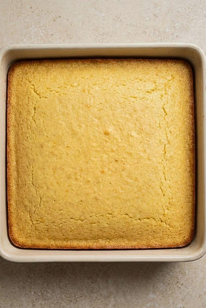 Freshly baked healthy cornbread in a square pan, just out of the oven, as shown in the step-by-step instructions for the Healthy Cornbread recipe.