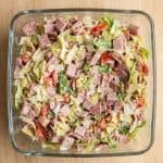 Bowl of freshly mixed hoagie dip with chopped deli meats, lettuce, and tomatoes.