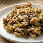 Plate of old-fashioned giblet stuffing made with bread cubes, turkey giblets, celery, and onions. Classic holiday side dish.