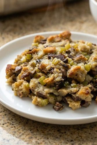 Plate of old-fashioned giblet stuffing made with bread cubes, turkey giblets, celery, and onions. Classic holiday side dish.