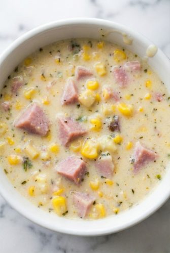 Thick and Creamy Slow Cooker Corn Chowder Recipe Bowl of creamy slow cooker corn chowder with chunks of ham and sweet corn, ready to serve.