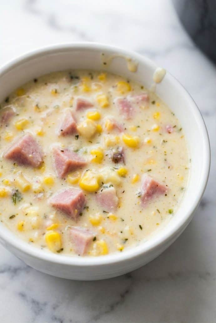 Close-up of a bowl of creamy ham and corn chowder made in the slow cooker, ready to eat.