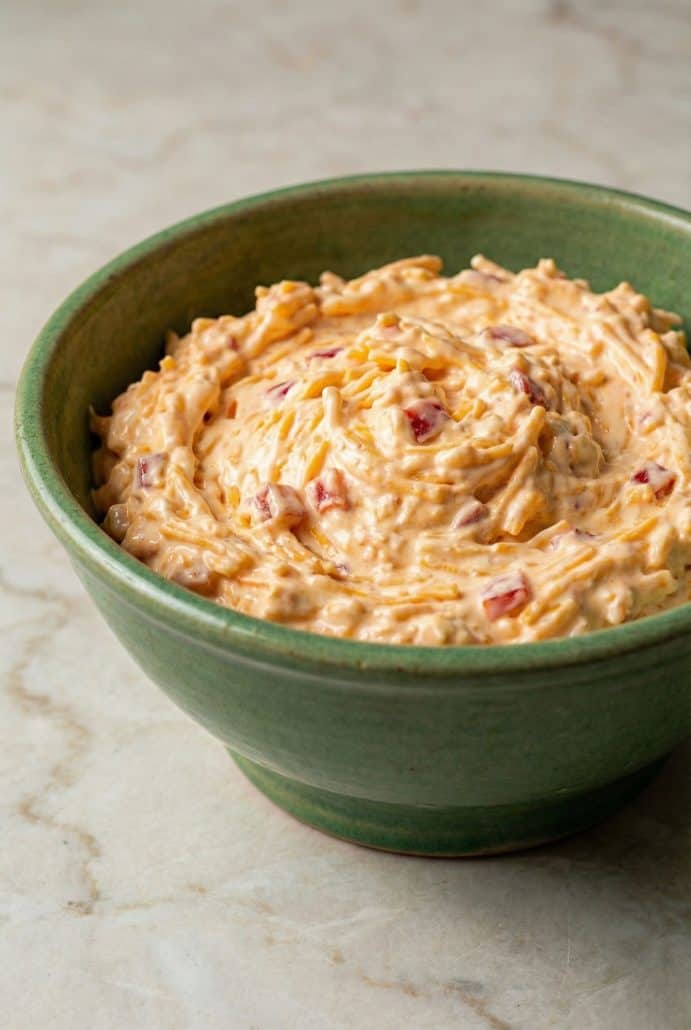 Creamy homemade Southern pimento cheese in a green bowl. Ready to serve as a dip, spread, or sandwich filling.