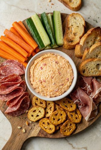 Homemade Southern Pimento Cheese Recipe - Creamy and Tangy Southern pimento cheese served on a charcuterie board with pretzels, crackers, veggies, and cured meats.