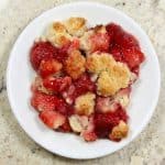 That strawberry cobbler looks absolutely delicious. Golden, crumbly topping and juicy strawberries bursting with flavor.