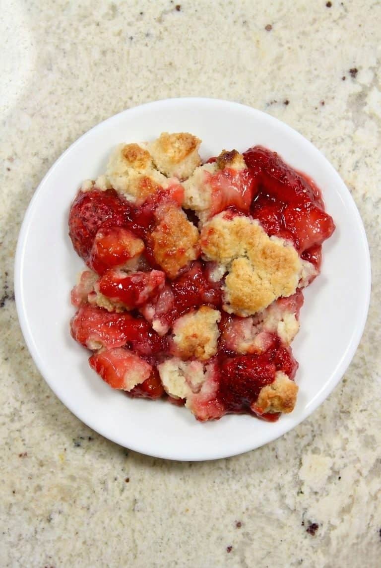 That strawberry cobbler looks absolutely delicious. Golden, crumbly topping and juicy strawberries bursting with flavor.