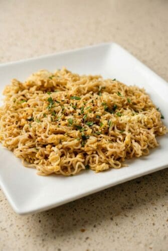 TikTok Ramen Noodles With Everything Bagel Seasoning Close-up of finished TikTok Ramen with egg and chopped green onions served on a white plate.