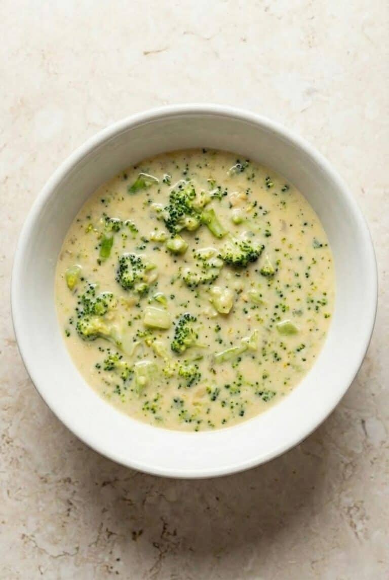 Creamy homemade broccoli cheese soup served in a white bowl, highlighting the rich, cheesy texture.