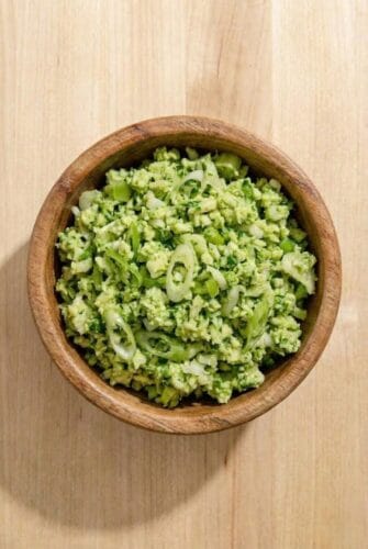 Fresh Green Goddess Salad Viral TikTok Recipe A wooden bowl filled with TikTok Green Goddess Salad, featuring finely chopped cabbage, cucumbers, and scallions tossed in a creamy green dressing.