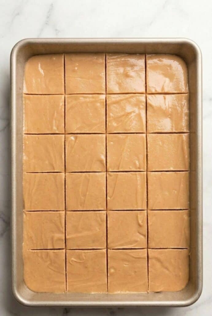 Overhead view of creamy peanut butter fudge cut into neat squares in a 9x13 pan, ready to serve from this easy homemade fudge recipe.