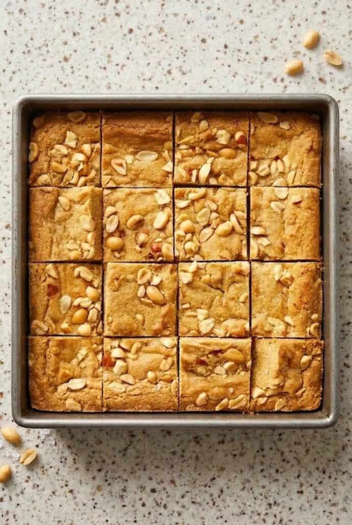 Overhead view of chewy peanut butter brownies baked in a square pan and cut into even squares.