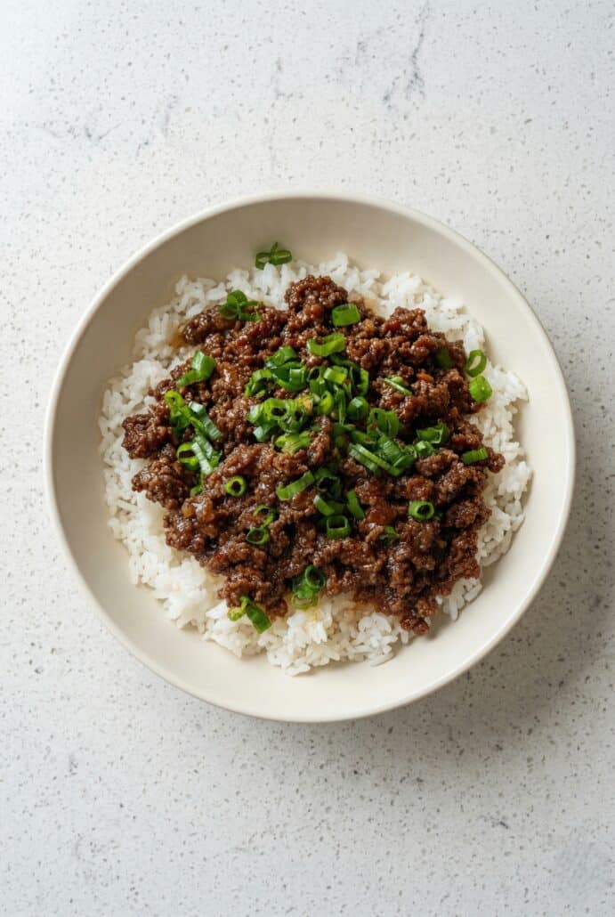 Korean ground beef bowl served over rice with green onions, perfect for a quick and easy weeknight meal.