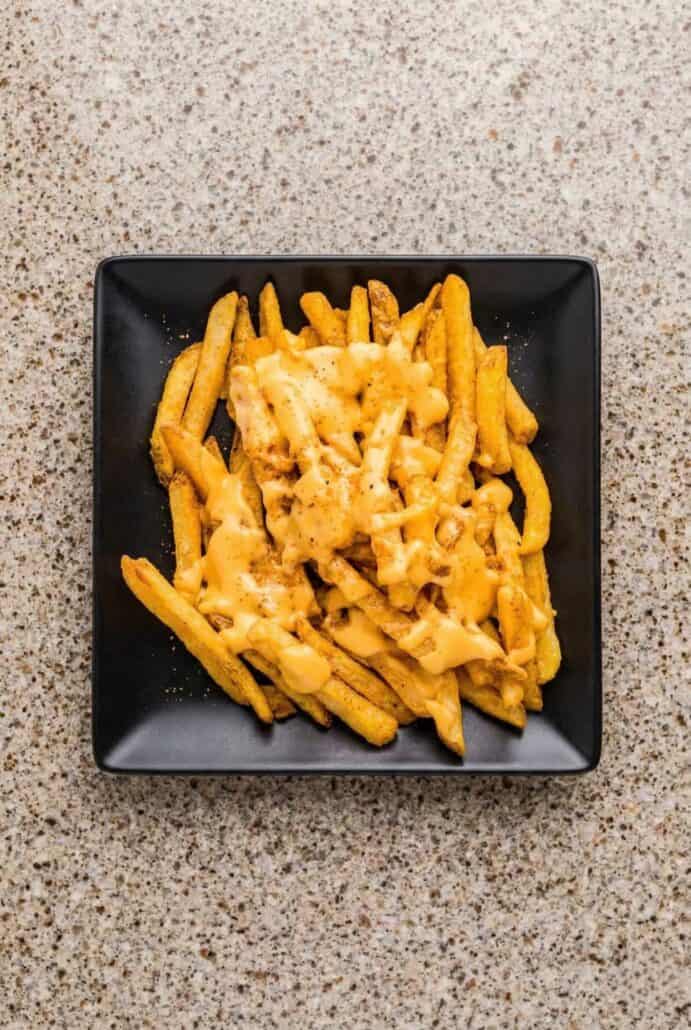 Louisiana Voodoo fries coated in creamy cheese sauce, served hot as a cheesy loaded fries.
