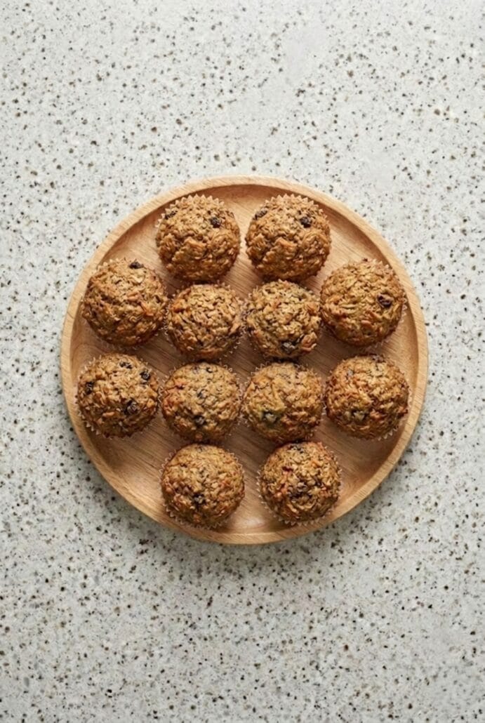 Plate of homemade morning glory muffins with carrots, raisins, and nuts, ready to serve as a wholesome breakfast or snack.