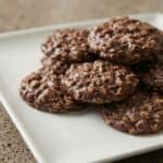 Stack of homemade no-bake chocolate oatmeal cookies on a plate, showing the rich chocolate and oat texture.