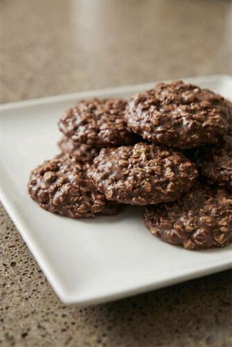Easy No-Bake Chocolate Oatmeal Cookies | Done in 20 Minutes with No Oven Stack of homemade no-bake chocolate oatmeal cookies on a plate, showing the rich chocolate and oat texture.