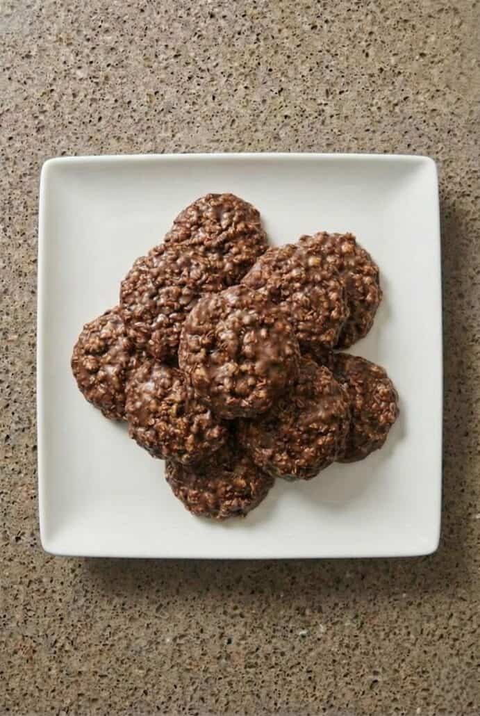 Plate of homemade no-bake chocolate oatmeal cookies made with cocoa, peanut butter, and oats.