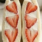 Strawberry sando with whipped cream and fresh strawberry slices arranged inside soft white bread.
