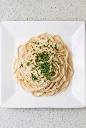 Fettuccine Alfredo Recipe (Creamy, Cheesy & Restaurant-Style!) Creamy fettuccine Alfredo plated and topped with fresh parsley.