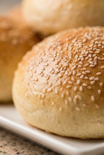 Soft & Fluffy Homemade Hamburger Buns | No-Fail Recipe Sesame seed hamburger bun close-up for homemade hamburger buns.