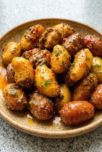 Honey Mustard Potatoes Recipe - A Perfect Side Dish Golden honey mustard baby potatoes garnished with chives, served as an easy skillet side dish.