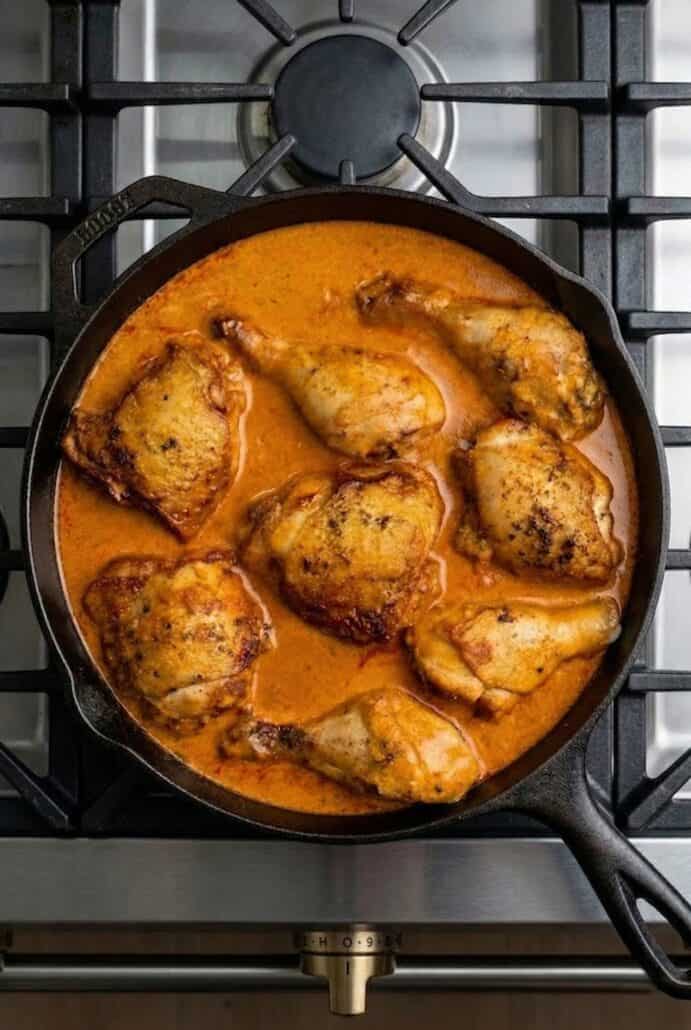 Skillet Hungarian chicken paprikash simmering in creamy paprika sauce.