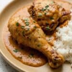 Creamy Hungarian chicken paprikash with rice, showing tender chicken in rich paprika sauce.